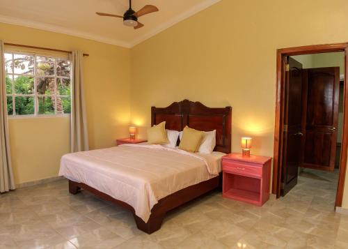 una camera da letto con un letto grande con due comodini di Hotel la Saladilla Beach Club a Santa Cruz de Barahona