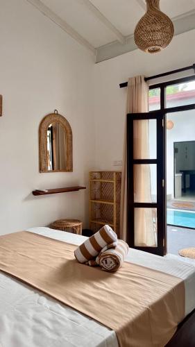 a bedroom with a large bed with a window at Casa Sinabowewa in Ahangama