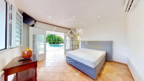 Ένα ή περισσότερα κρεβάτια σε δωμάτιο στο Villa spacieuse à Le Vauclin avec piscine