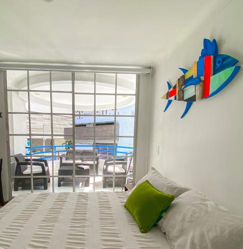 a bedroom with a bed and a view of a balcony at Quiet studio apartment one block from the beach in Playa Bello Horizonte