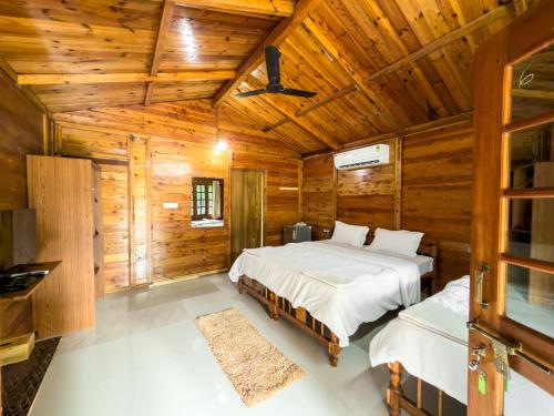 Ένα ή περισσότερα κρεβάτια σε δωμάτιο στο Laughing Buddha Palolem