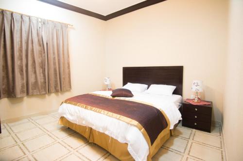 a bedroom with a large bed and a window at Qsr Al Lolo in Sakakah