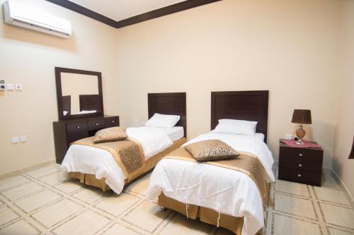 Postel nebo postele na pokoji v ubytování Qsr Al Lolo