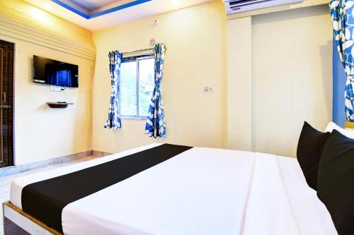 Ένα ή περισσότερα κρεβάτια σε δωμάτιο στο Hotel O CITY PLACE