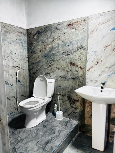 a bathroom with a toilet and a sink at Werala Beach Resort in Kalpitiya