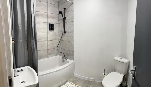 a bathroom with a shower and a toilet and a bath tub at Family & Contractor Haven Suites Mexborough in Mexborough