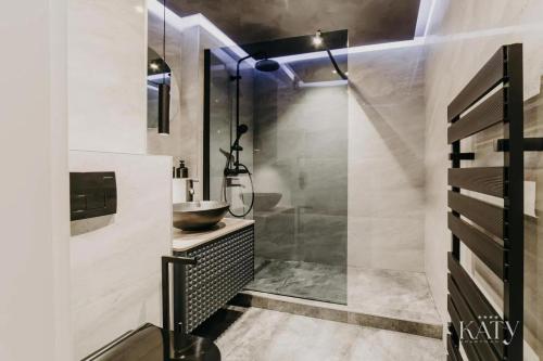 a bathroom with a sink and a shower at Apartman KATY in Vukovar