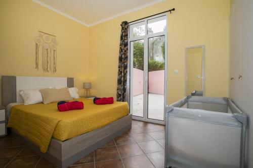 a bedroom with a bed and a sliding glass door at Furnas Cozy Inn in Furnas
