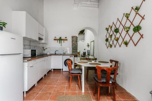 a kitchen with a table and chairs in a kitchen at Lovely Stay Arucas in Arucas