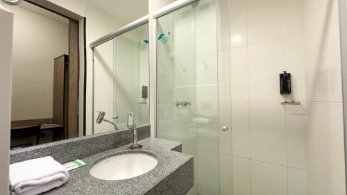 a bathroom with a sink and a shower at I-Hotel Piracicaba in Piracicaba