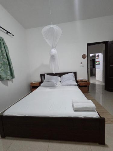 a bedroom with a bed with a net on it at Passadeira Garden in São Tomé