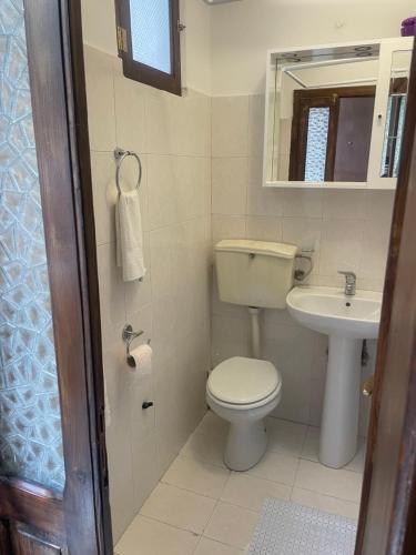 a small bathroom with a toilet and a sink at Da nonna Maria in Celano