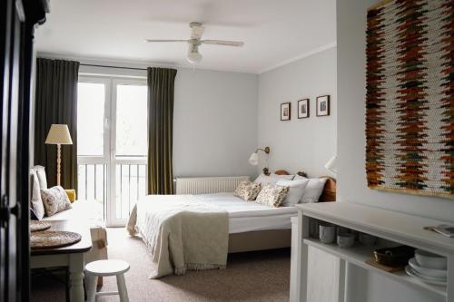 a white bedroom with a bed and a window at Busola House in Stegna