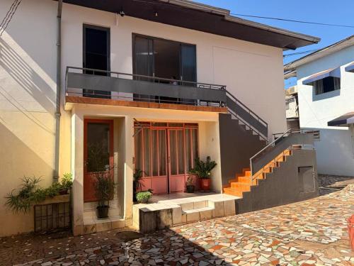 a house with a staircase and a balcony at Casa do Mauro in Foz do Iguaçu