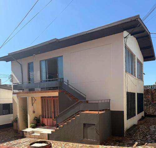 a house with a staircase on the side of it at Casa do Mauro in Foz do Iguaçu
