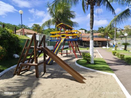 a playground in a park with a slide at Apartamento São Pedro da Aldeia frente para lagoa in São Pedro da Aldeia
