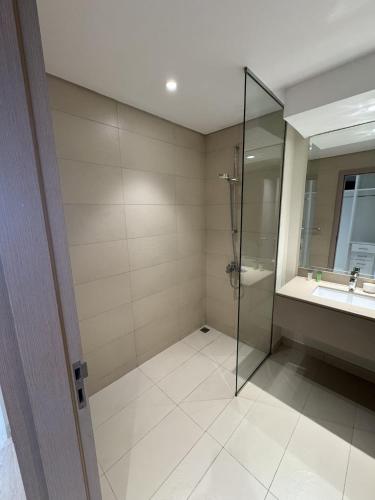 a bathroom with a glass shower and a sink at Family-Friendly 2BR on Yas Playground access in Yas Island