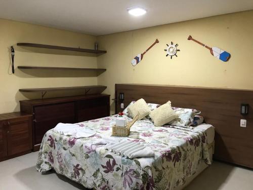 a bedroom with a large bed with a star on the wall at AP 104 - Flecheiras Residence in Flecheiras