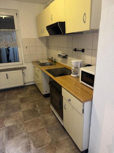a kitchen with yellow cabinets and a counter top at Dorfplatz in Klötze