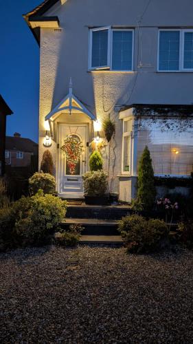 a house with a christmas wreath on the front door at Tropical Garden Oasis Rooms in Birmingham