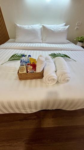 a basket of towels and toiletries on a bed at Cha homestay in Phanom