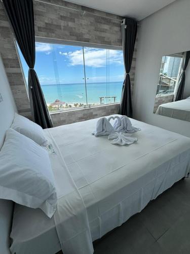 En eller flere senge i et værelse på Flat Mirante Alto do Cruzeiro