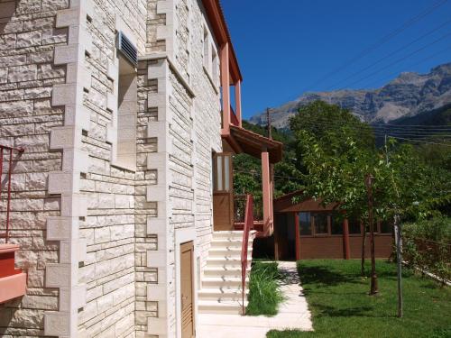 a side view of a house with mountains in the background at Xenonas Kypseli in Kipseli