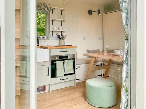 a small kitchen with a table and a stove at The Coop in Broadway
