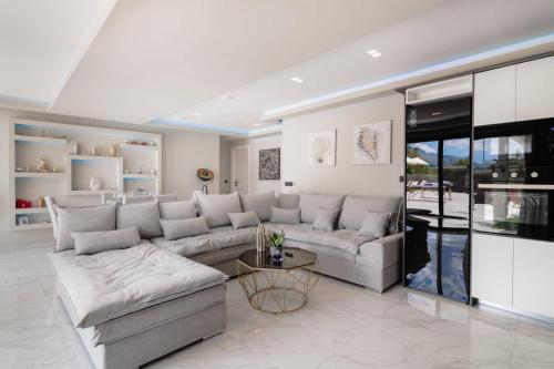 a living room with a couch and a table at Rua Luxury Villa in Zakynthos