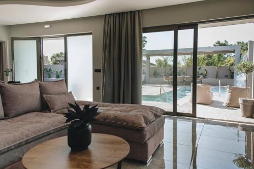 a living room with a couch and a table at Mat Luxury Villa in Zakynthos