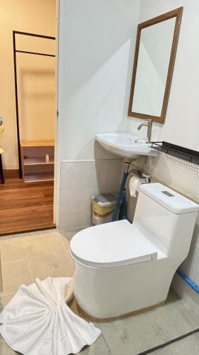 a bathroom with a toilet and a sink at Cha homestay in Phanom