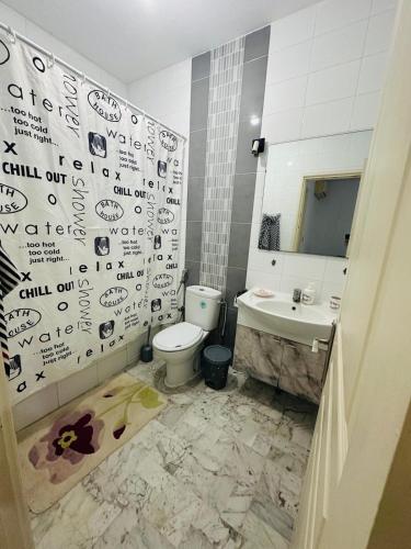 a bathroom with a toilet and a sink at Eden Cozy Airport in El Aouina Station