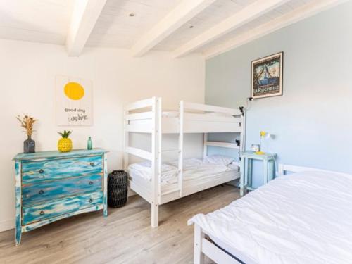 a bedroom with a white bunk bed and a blue dresser at Maison familiale avec piscine pour 9 personnes - FR-1-835-4 in Le Bois-Plage-en-Ré