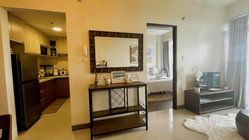 a living room with a table and a mirror at Ocean Verde Suite Boracay in Boracay