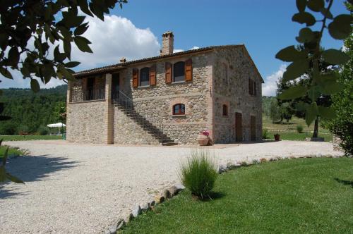 an old stone house with stairs on the side of it at Solaria Orvieto in Orvieto