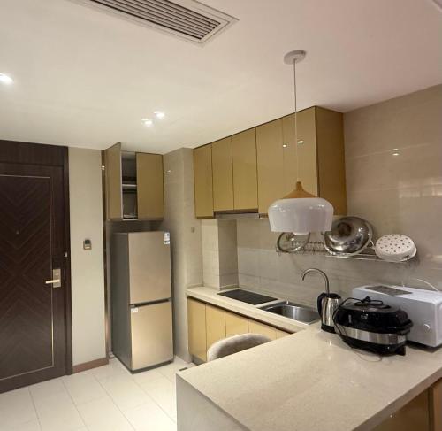 a kitchen with a sink and a counter top at NAGA Frontier Apartment in Vientiane