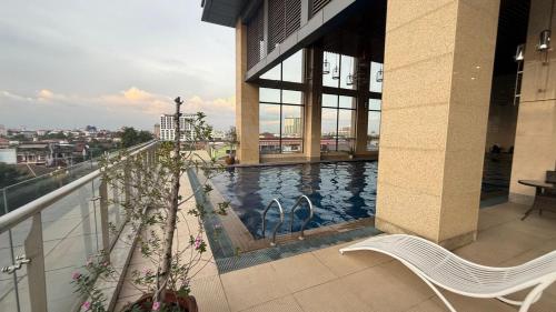 a balcony with a swimming pool on a building at NAGA Frontier Apartment in Vientiane
