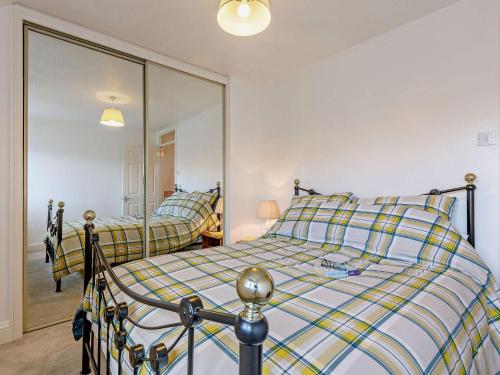 a bedroom with two beds and a large mirror at 3 Bed in Haselbury Plucknett 83943 in Haselbury Plucknett