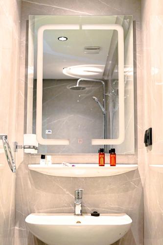 a bathroom with a mirror and a sink at Riad Qodwa in Fourou