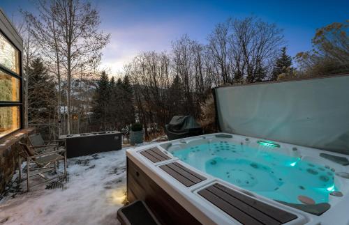 a hot tub on a patio in the snow at Aspen Silverado in Aspen Valley Hospital Heliport