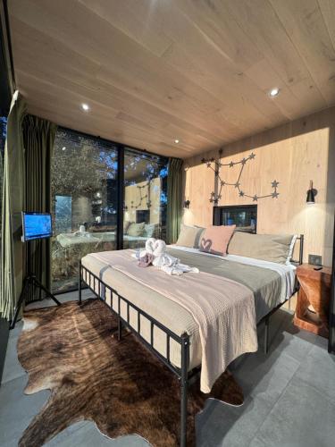a bedroom with a bed with a teddy bear on it at Perseus at The Retreat in Fredericksburg