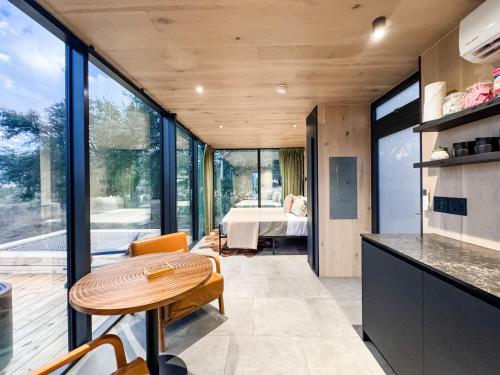 a kitchen with a table and a room with a bedroom at Perseus at The Retreat in Fredericksburg