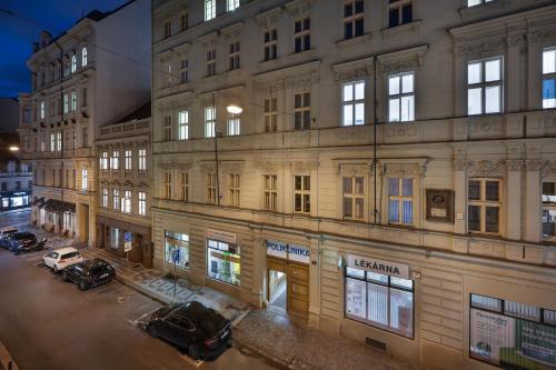 a building with two cars parked in front of it at U Šuterů Boutique Hotel in Prague