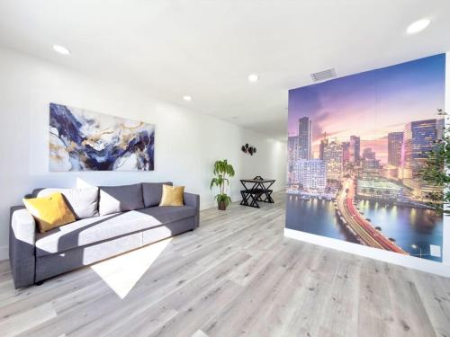 a living room with a couch and a painting on the wall at Miami Lux Retreat - Free Parking - Near Brickell in Miami