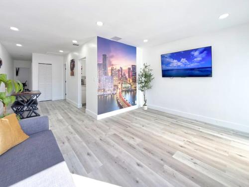 a living room with a couch and a painting on the wall at Miami Lux Retreat - Free Parking - Near Brickell in Miami