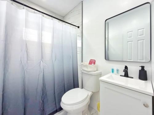 a bathroom with a shower and a toilet and a sink at Miami Lux Retreat - Free Parking - Near Brickell in Miami