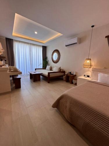 a large hotel room with a bed and a couch at Casa Makräm in Tulum