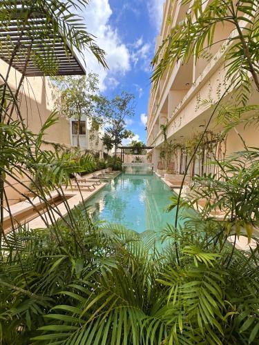 a swimming pool in the middle of a building at Casa Makräm in Tulum