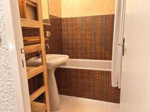 a small bathroom with a sink and a bath tub at Studio coin montagne au pied des pistes - 4 couchages - Risoul 1850 - FR-1-330-88 in Risoul
