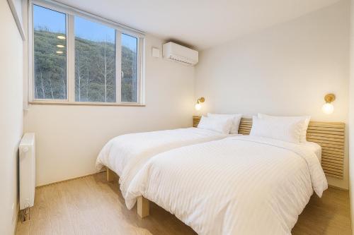 Voodi või voodid majutusasutuse Kizen Kimobetsu toas